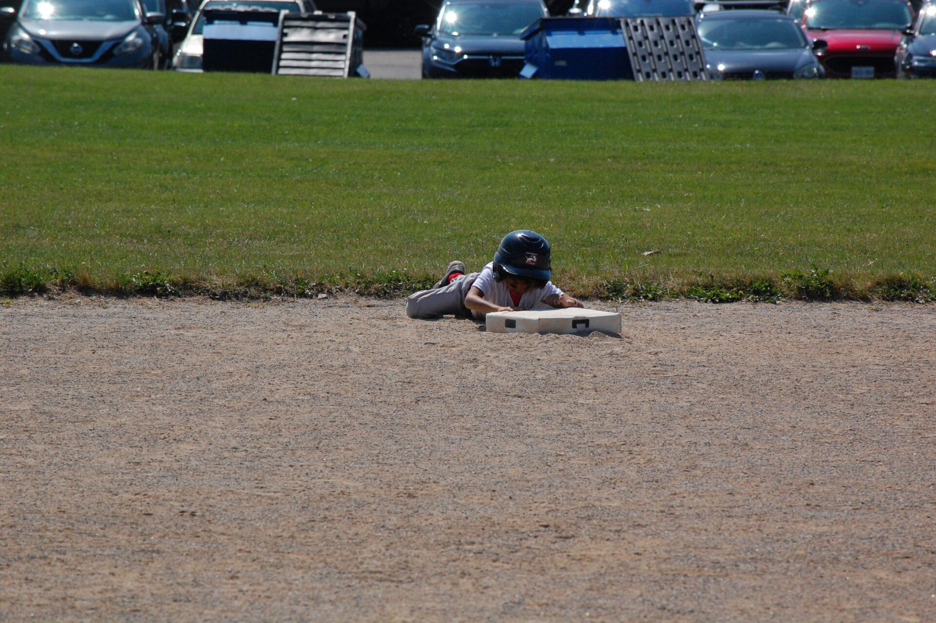 Kids playing t-ball game on the ground